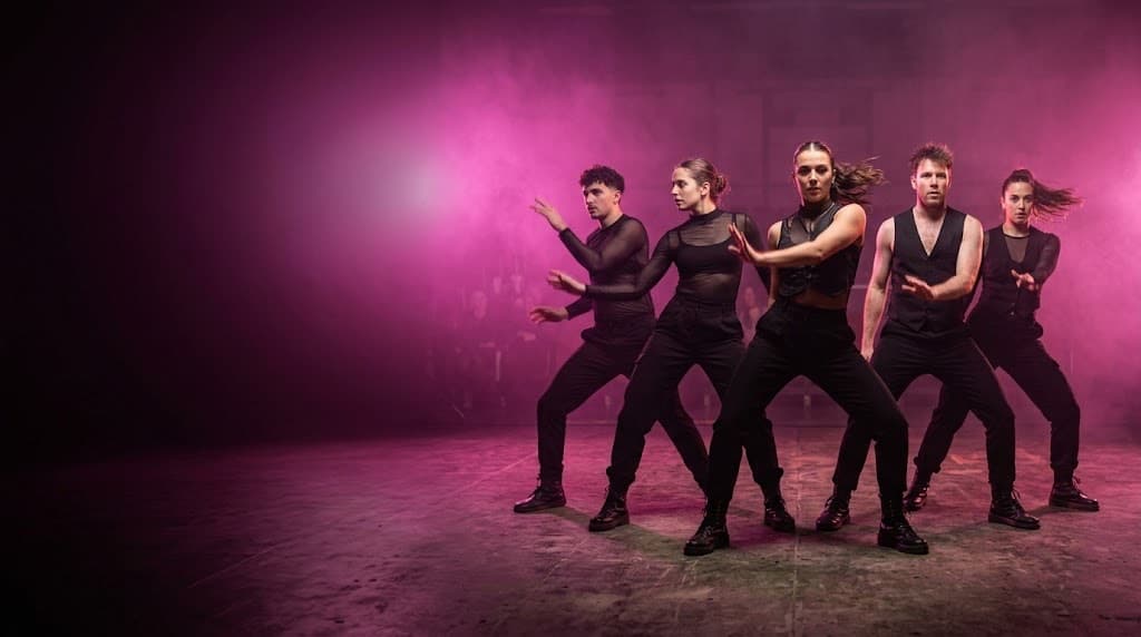 A dance group performing on stage